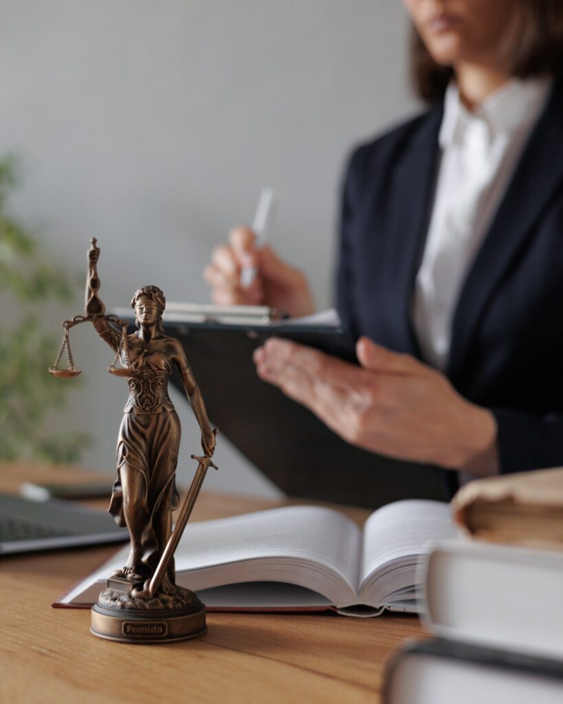 selective focus, female lawyer or judge checks documents or a contract and makes notes in a notebook